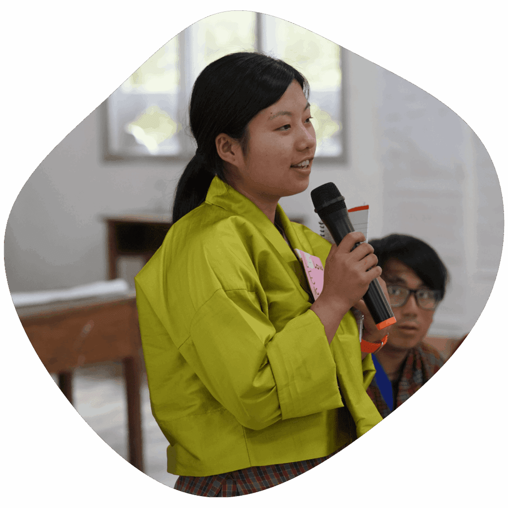 women wearing green tego holding mic and speaking to the crowd