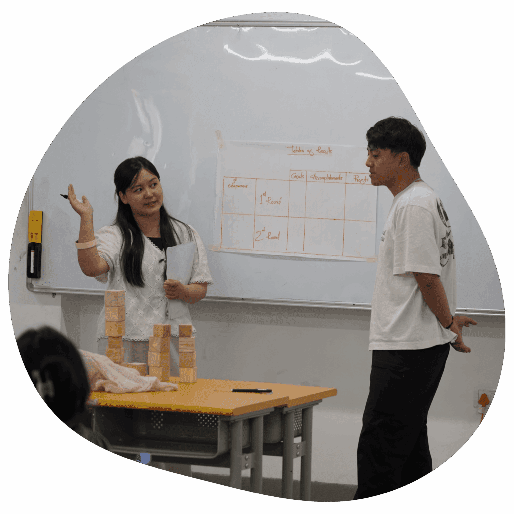 a women explaining the concept to a guy, teaching entrepreneur life through tower building