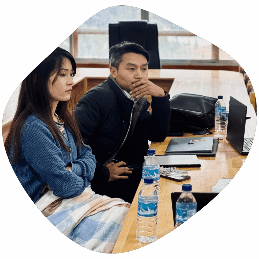 women sitting with crossed hand and man leaning on the table and listening attentively