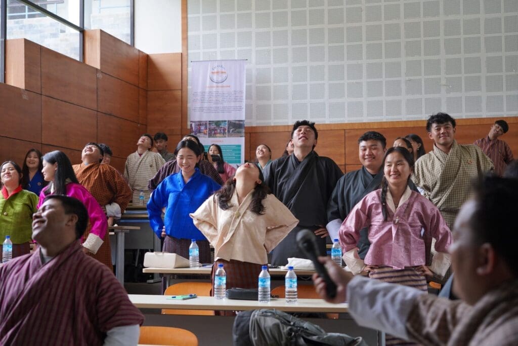 people having a laughing therapy, looking up, laughing with hands on their hips