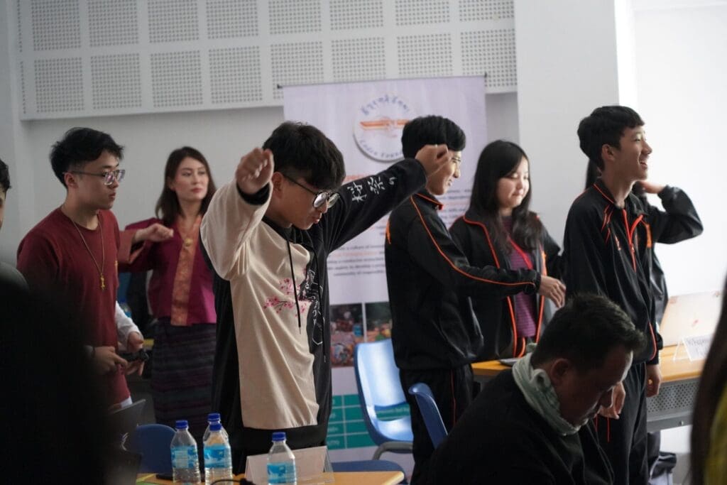 boy wearing glasses, raising his hands up, brain brake during Hackathon